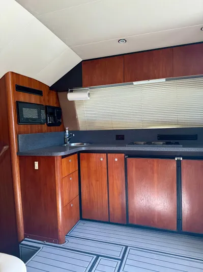 Martin Yacht Photos Pics 2002 Luhrs 36 Convertible yacht kitchen with wood cabinets and modern appliances.