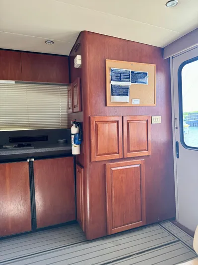 Martin Yacht Photos Pics Interior of 2002 Luhrs 36 Convertible yacht with wooden cabinetry and corkboard.