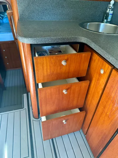 Martin Yacht Photos Pics Wooden cabinetry and drawers in 2002 Luhrs 36 Convertible boat kitchen area.
