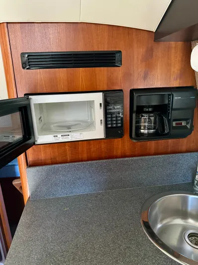 Martin Yacht Photos Pics 2002 Luhrs 36 Convertible kitchen with microwave, coffee maker, and sink.