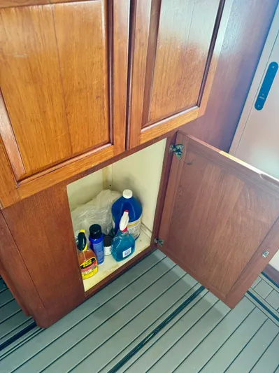 Martin Yacht Photos Pics Open wooden cabinet on 2002 Luhrs 36 Convertible boat with cleaning supplies inside.