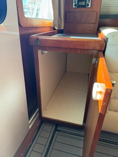 Martin Yacht Photos Pics Open wooden cabinet inside 2002 Luhrs 36 Convertible boat interior.