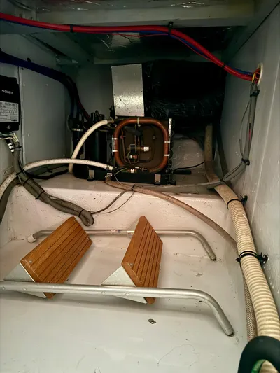 Martin Yacht Photos Pics Engine room of 2002 Luhrs 36 Convertible boat with mechanical components and hoses.