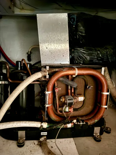 Martin Yacht Photos Pics 2002 Luhrs 36 Convertible engine room with copper piping and mechanical components.