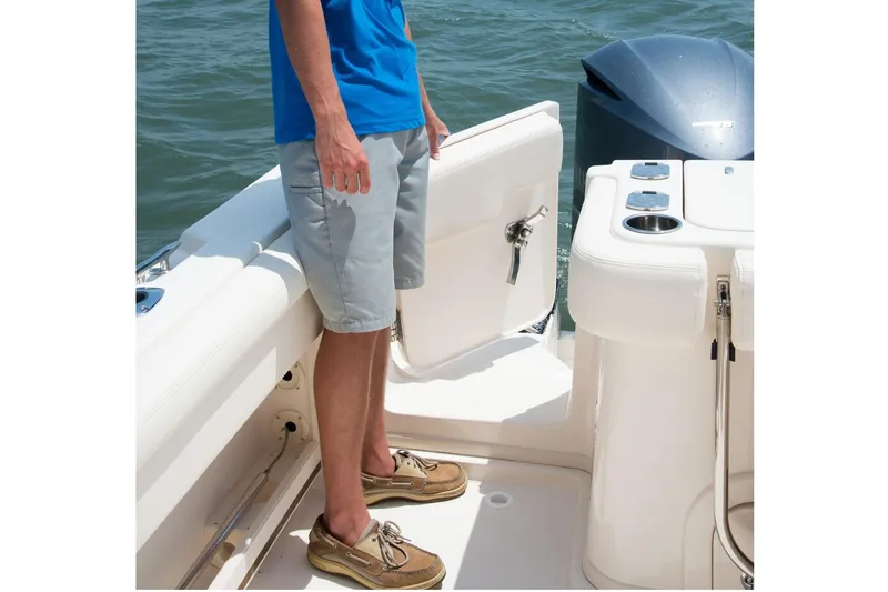  Yacht Photos Pics Man standing on 2018 Grady-White Express 330 boat deck near water.