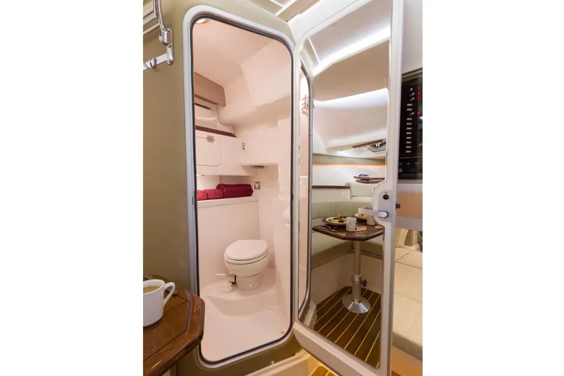  Yacht Photos Pics 2018 Grady-White Express 330 cabin interior with bathroom and dining area.
