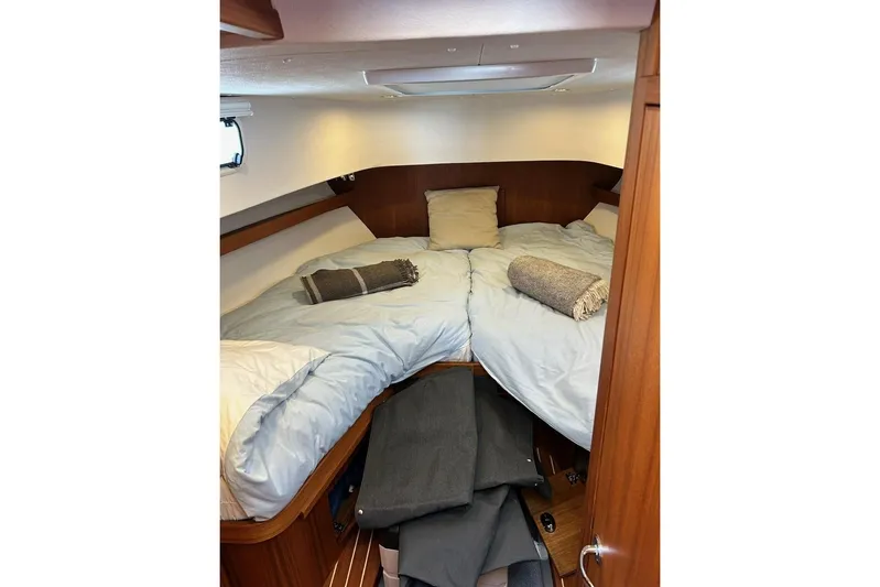  Yacht Photos Pics Cozy cabin interior of 2022 Botnia Targa 37 with neatly arranged bedding.