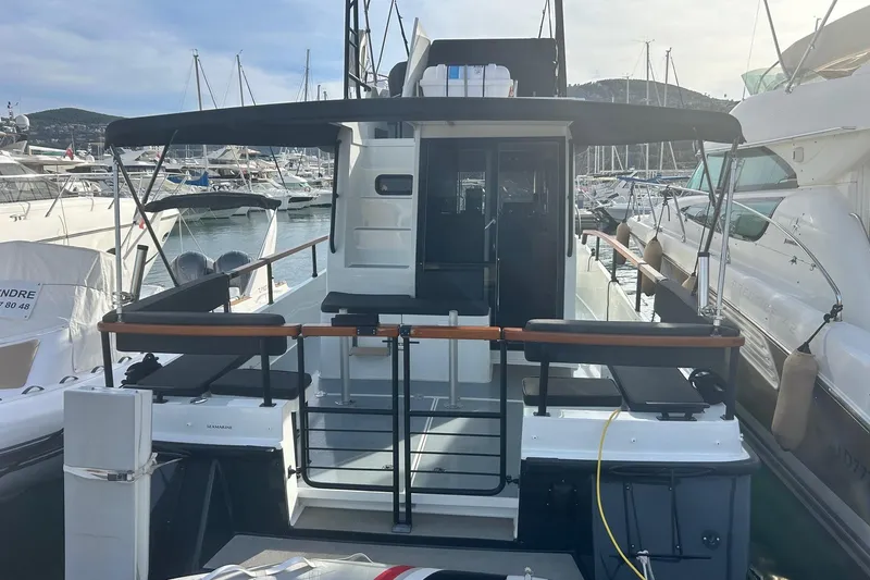  Yacht Photos Pics 2022 Botnia Targa 37 yacht docked at marina, featuring spacious deck and canopy.