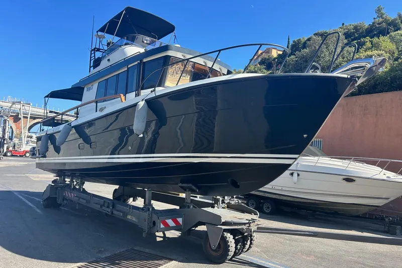 Yacht Photos Pics 2022 Botnia Targa 37 boat on trailer in sunny marina setting.