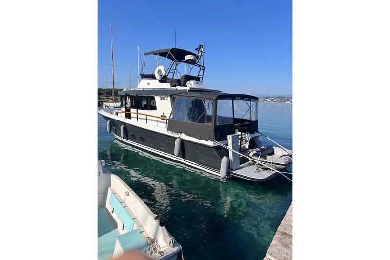  Yacht Photos Pics 2022 Botnia Targa 37 yacht docked in clear blue water, side view.