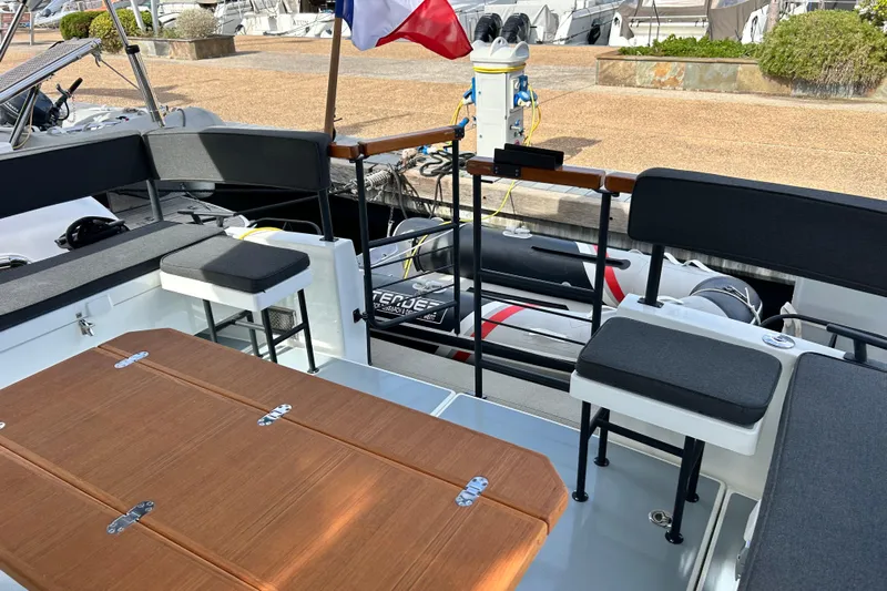  Yacht Photos Pics 2022 Botnia Targa 37 boat interior with seating and table, docked at marina.