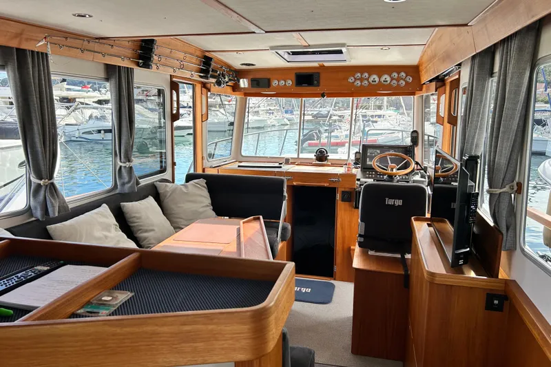  Yacht Photos Pics Interior of 2022 Botnia Targa 37 boat with modern helm and cozy seating.