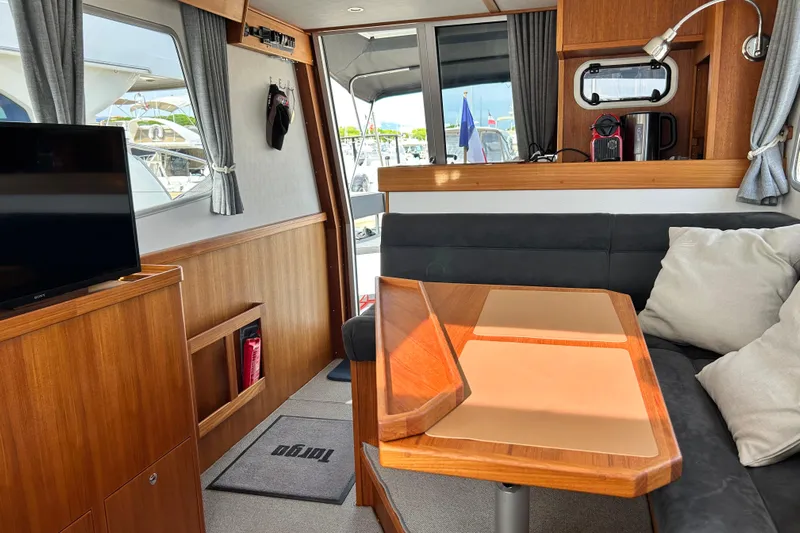  Yacht Photos Pics Interior of 2022 Botnia Targa 37 yacht with cozy seating and wooden finishes.