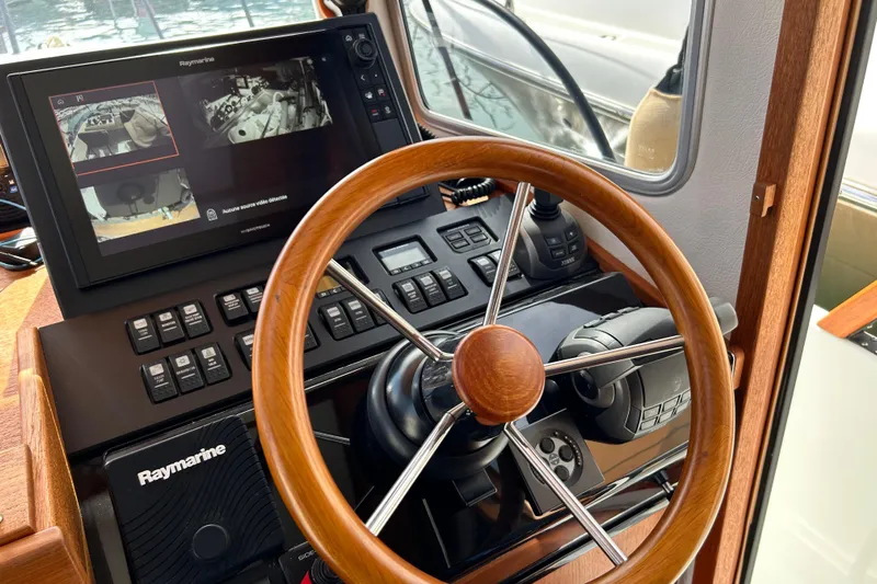  Yacht Photos Pics Steering wheel and control panel of 2022 Botnia Targa 37 boat with Raymarine display.