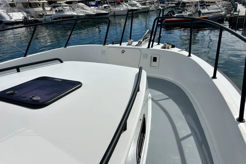  Yacht Photos Pics 2022 Botnia Targa 37 boat deck, docked in a marina with surrounding yachts.