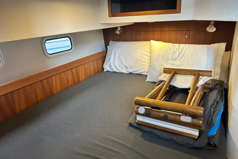  Yacht Photos Pics Cozy cabin interior of 2022 Botnia Targa 37 with bed and wooden ladder.