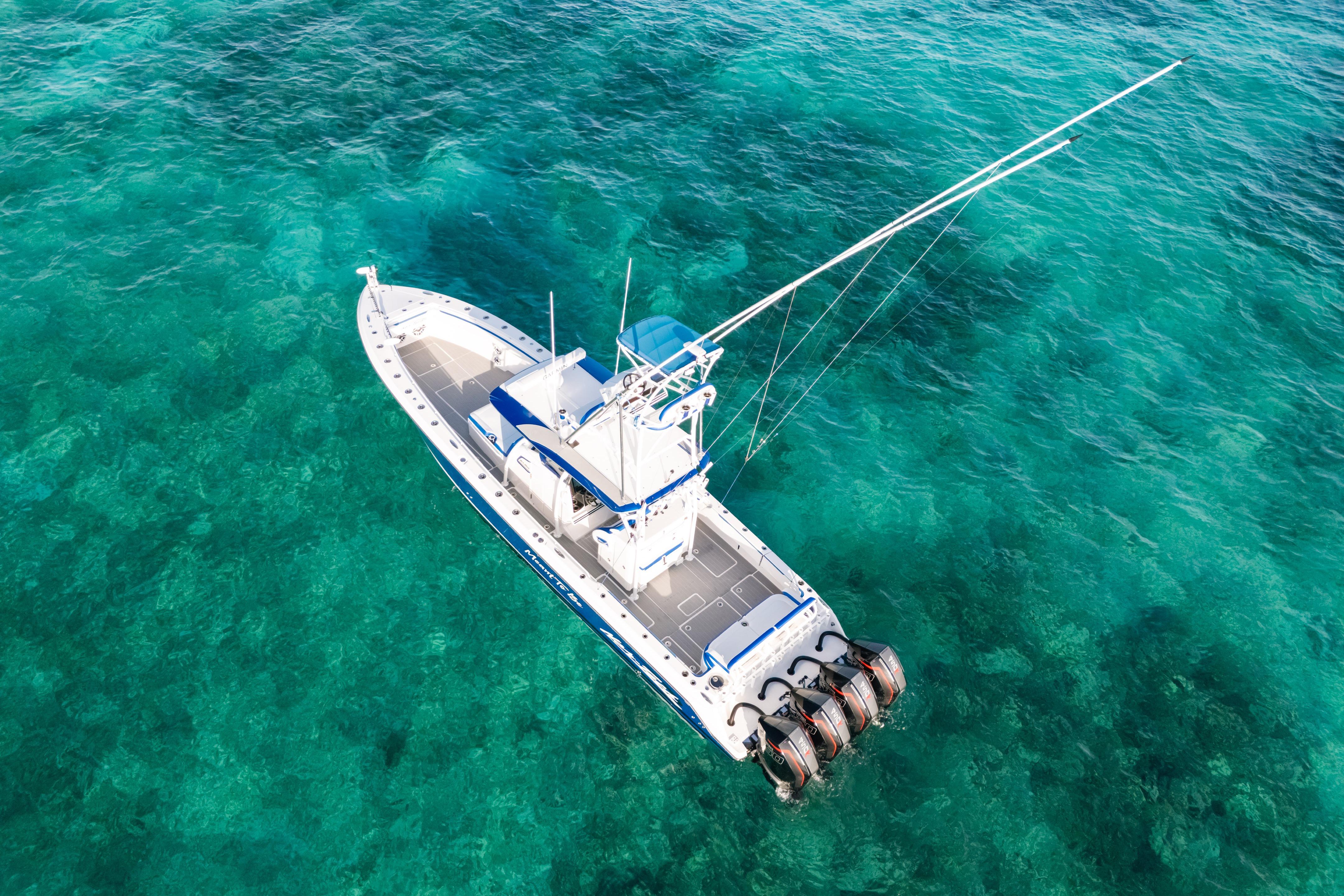 Aerial view of 2022 Nor-Tech 392 Super Fish boat on clear turquoise water.