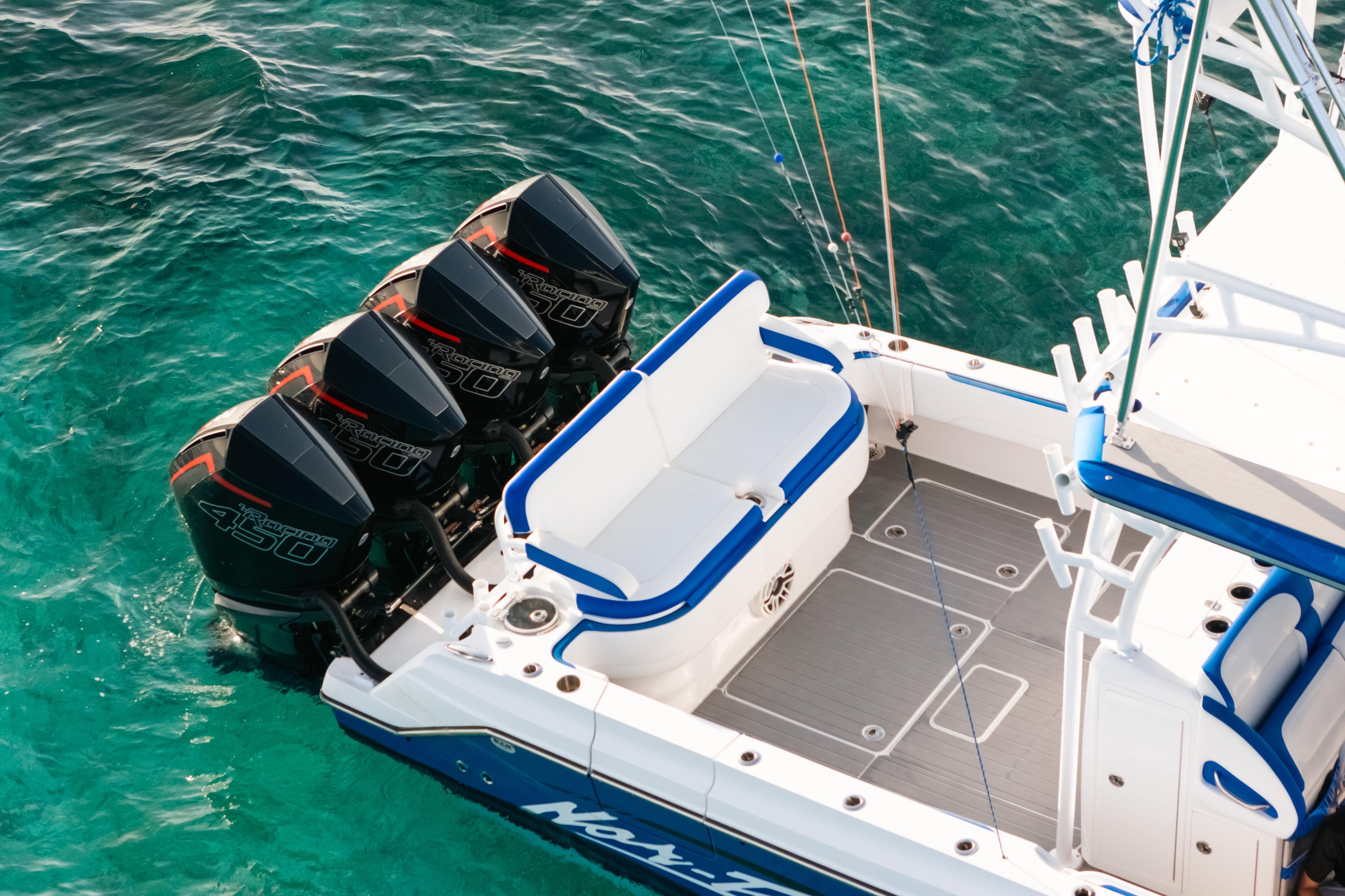 2022 Nor-Tech 392 Super Fish boat with four powerful outboard engines on turquoise water.