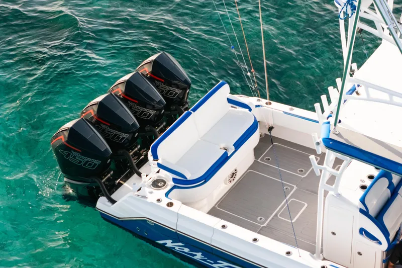  Yacht Photos Pics 2022 Nor-Tech 392 Super Fish boat with four powerful outboard engines on turquoise water.
