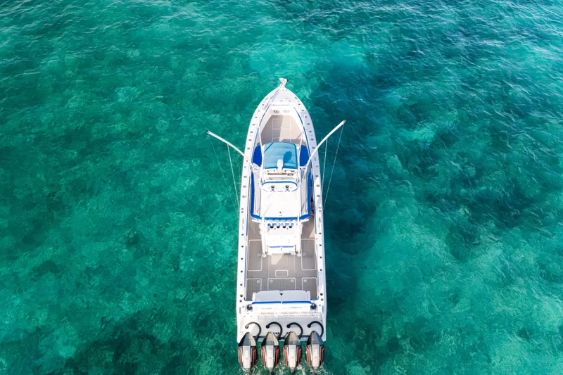  Yacht Photos Pics 2022 Nor-Tech 392 Super Fish boat on clear turquoise water, aerial view.