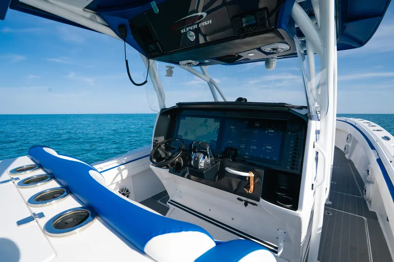  Yacht Photos Pics 2022 Nor-Tech 392 Super Fish boat interior with advanced navigation system and blue seating.