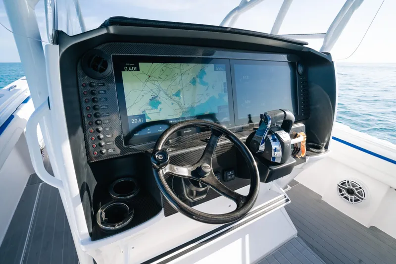  Yacht Photos Pics 2022 Nor-Tech 392 Super Fish boat dashboard with navigation screens and steering wheel.