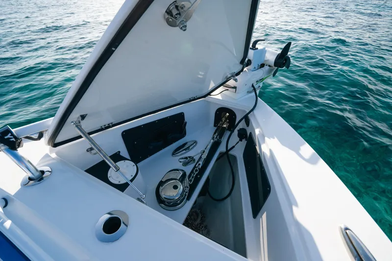  Yacht Photos Pics 2022 Nor-Tech 392 Super Fish boat anchor compartment with open lid, on clear blue water.