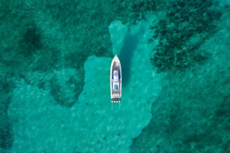  Yacht Photos Pics Aerial view of 2022 Nor-Tech 392 Super Fish boat on turquoise water.