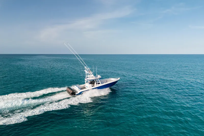  Yacht Photos Pics 2022 Nor-Tech 392 Super Fish boat cruising on open ocean under clear sky.