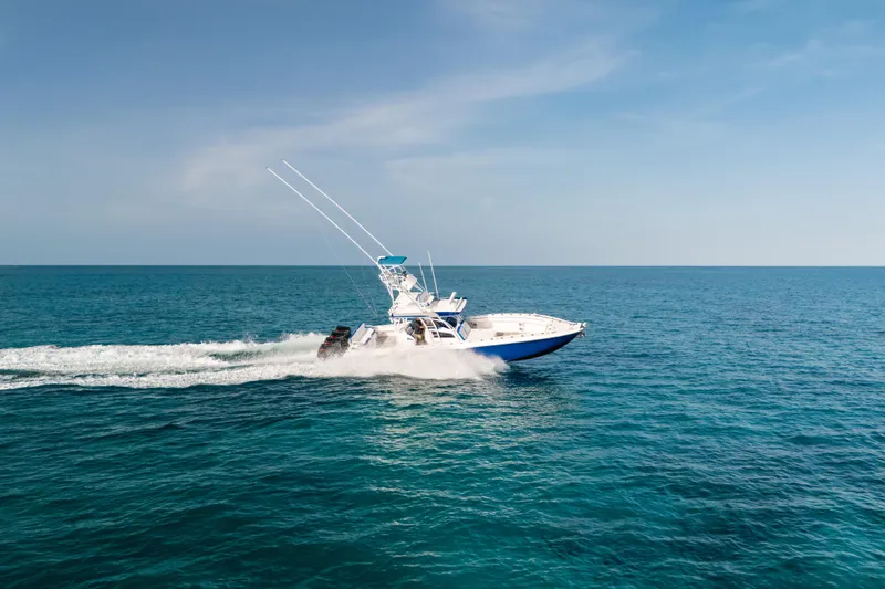  Yacht Photos Pics 2022 Nor-Tech 392 Super Fish boat cruising on open ocean under clear blue sky.