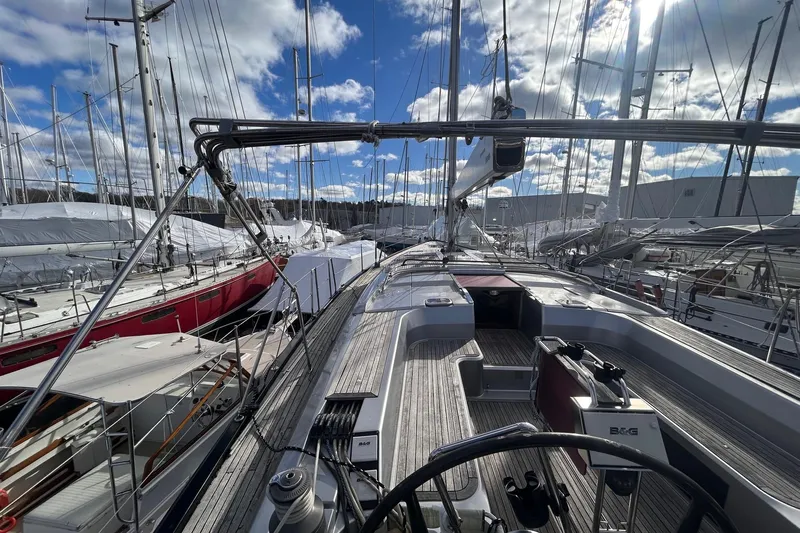  Yacht Photos Pics Sailing yacht Hanse 545, 2010 model, docked in a marina under a partly cloudy sky.