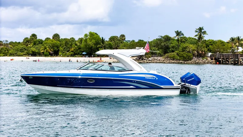  Yacht Photos Pics 2024 Formula 310 BR boat on water, blue and white design, tropical background.