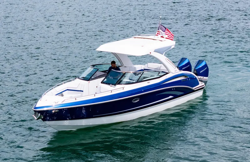  Yacht Photos Pics 2024 Formula 310 BR boat on water, featuring sleek design and dual outboard engines.