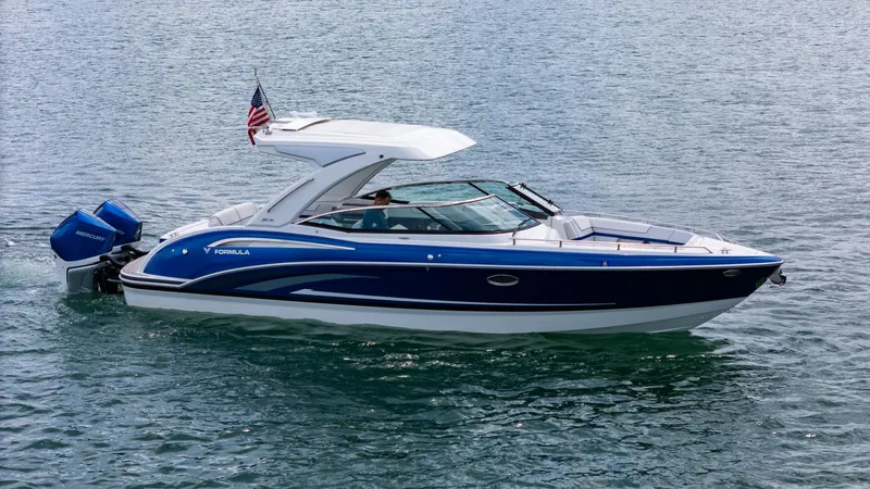  Yacht Photos Pics 2024 Formula 310 BR boat cruising on water with American flag.