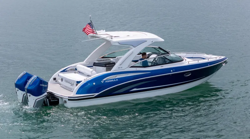  Yacht Photos Pics 2024 Formula 310 BR boat cruising on water with American flag.