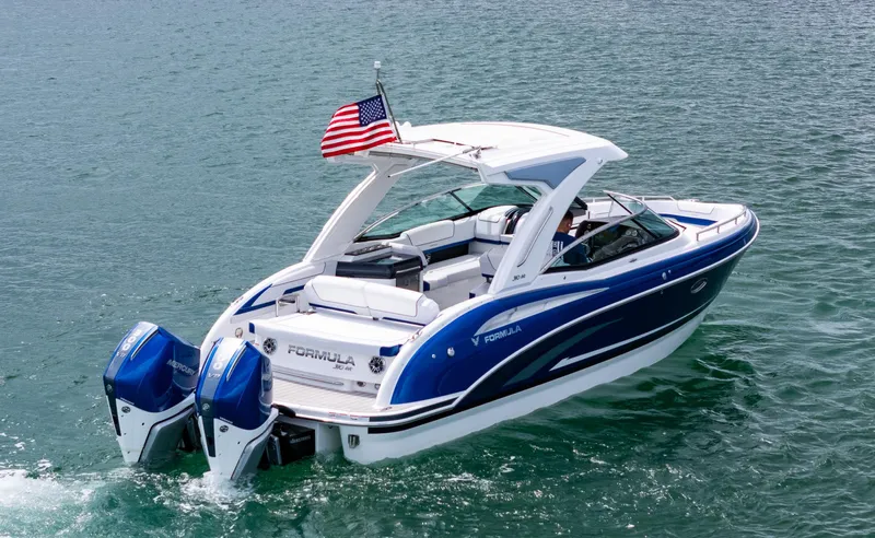  Yacht Photos Pics 2024 Formula 310 BR boat cruising on water with American flag.