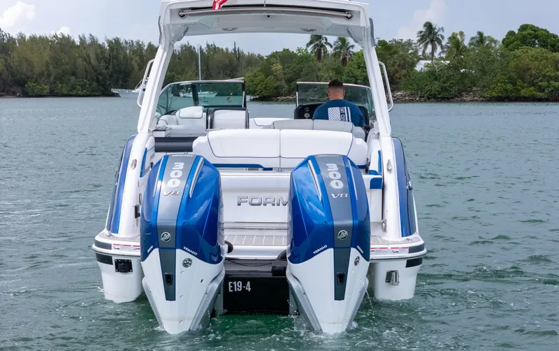  Yacht Photos Pics 2024 Formula 310 BR boat with dual 300 V8 engines on a scenic waterway.