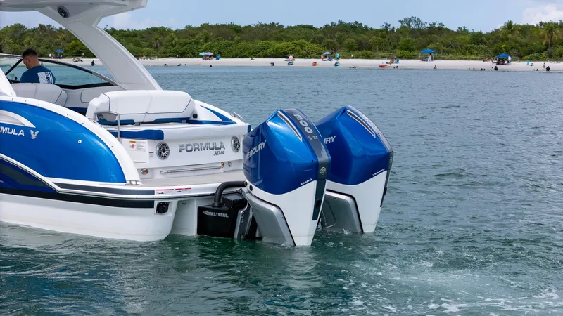  Yacht Photos Pics 2024 Formula 310 BR boat with dual Mercury outboard engines on a scenic waterway.