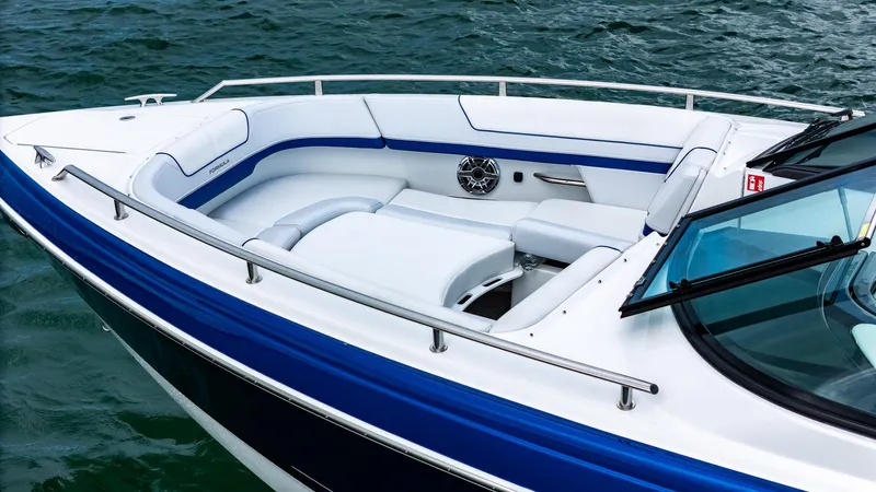 Yacht Photos Pics 2024 Formula 310 BR boat with sleek white and blue seating on water.