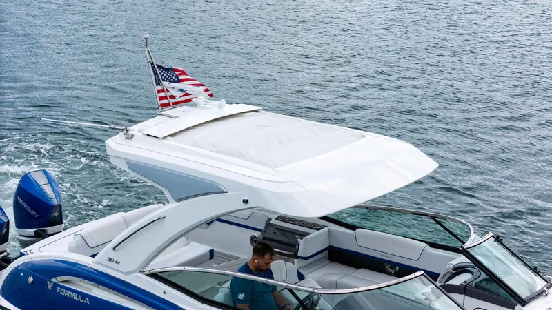  Yacht Photos Pics 2024 Formula 310 BR boat cruising on water with American flag.
