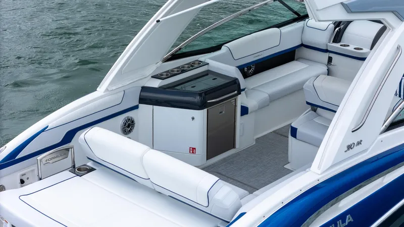  Yacht Photos Pics 2024 Formula 310 BR boat interior with white and blue seating, sleek design, and modern amenities.