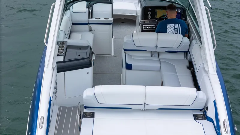  Yacht Photos Pics 2024 Formula 310 BR boat interior with white seating and modern dashboard on water.