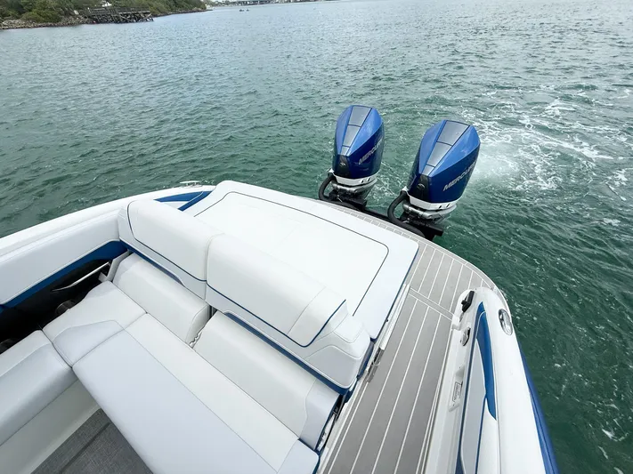  Yacht Photos Pics 2024 Formula 310 BR boat with twin Mercury outboard engines on a calm lake.