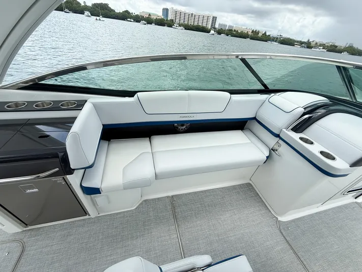  Yacht Photos Pics 2024 Formula 310 BR boat interior with white seating and scenic water view.