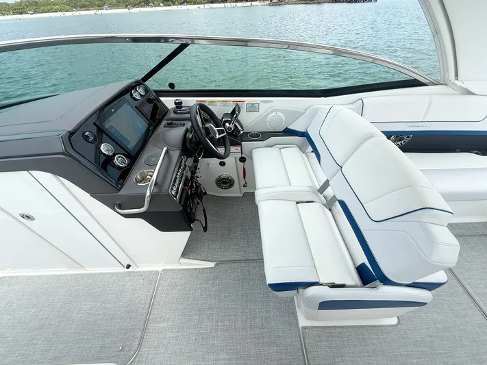  Yacht Photos Pics 2024 Formula 310 BR boat interior with modern dashboard and white seating.