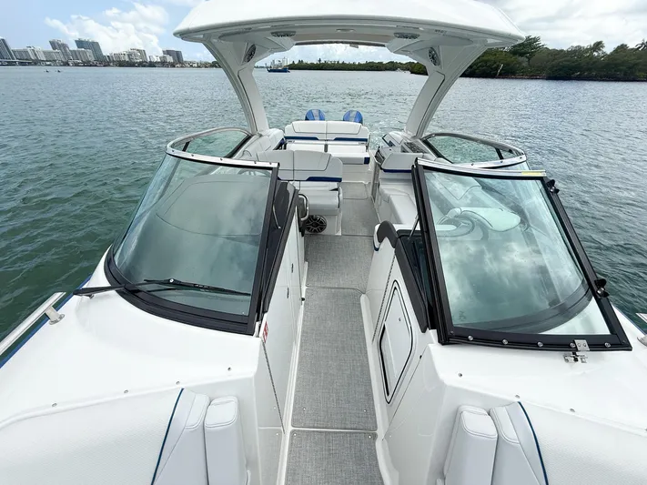  Yacht Photos Pics 2024 Formula 310 BR boat interior with open deck and waterfront view.