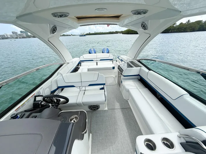  Yacht Photos Pics Luxurious 2024 Formula 310 BR boat interior with spacious seating and modern design on the water.