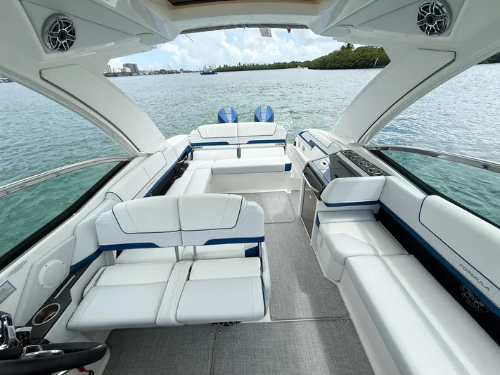  Yacht Photos Pics Luxurious 2024 Formula 310 BR boat interior with white seating and modern amenities on the water.