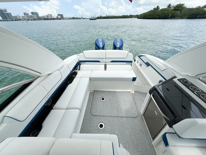  Yacht Photos Pics 2024 Formula 310 BR boat interior with luxurious seating and scenic water view.
