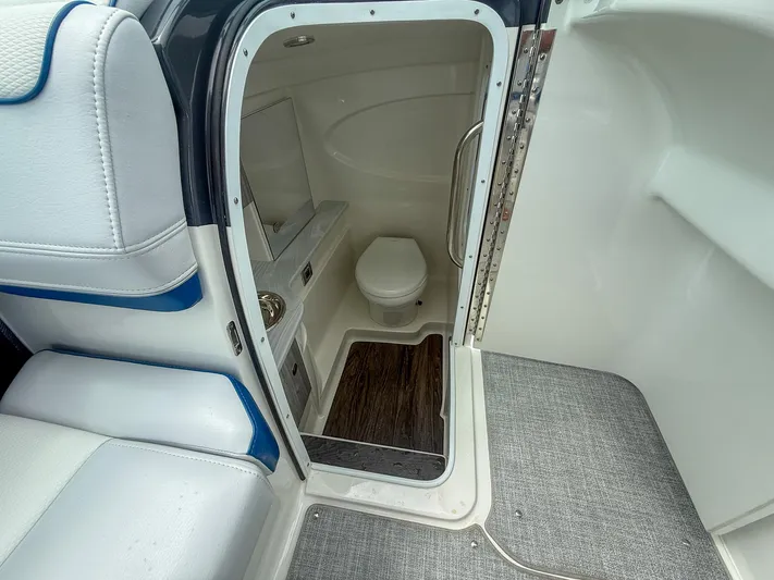  Yacht Photos Pics 2024 Formula 310 BR boat interior with compact bathroom and modern amenities.